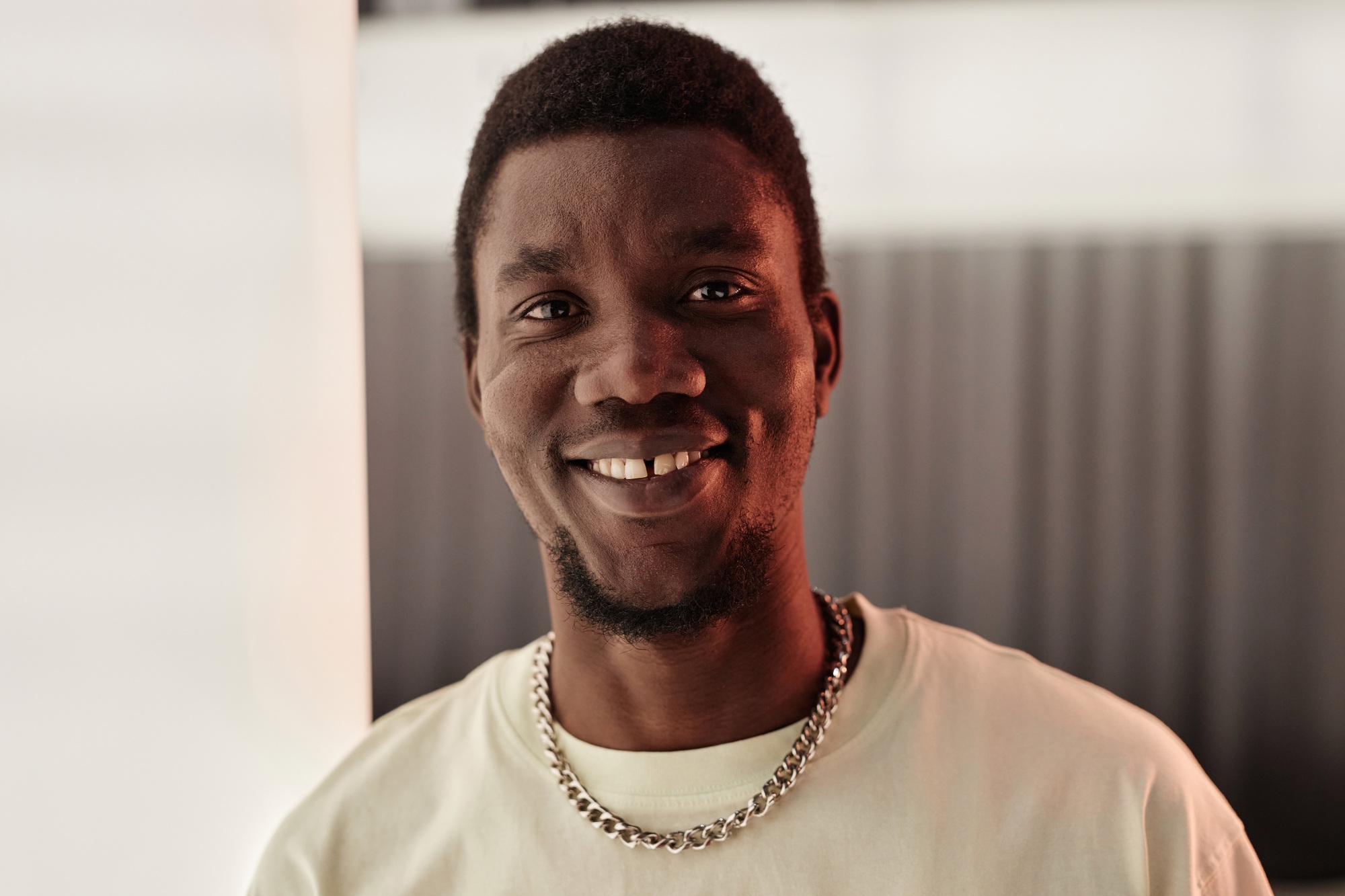 Young Black Man Looking at Camera and Smiling with Tooth Gap