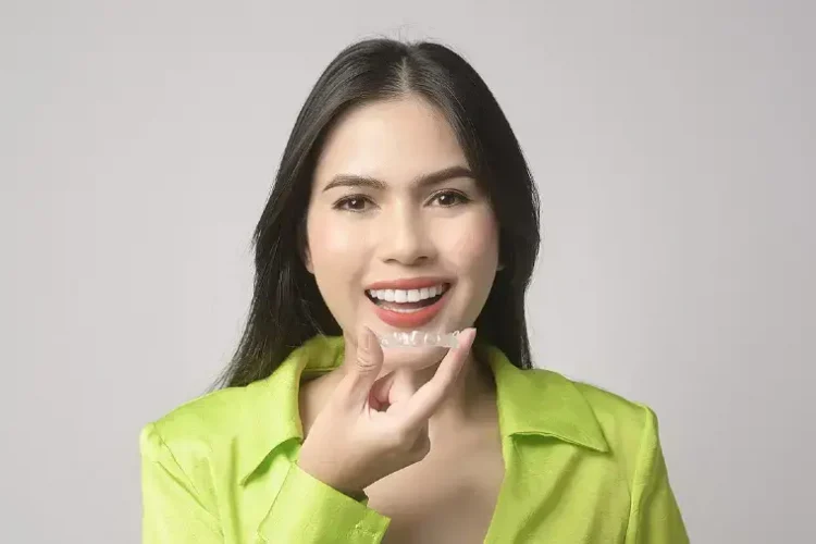 bigstock-Young-Smiling-Woman-Holding-In-460974711